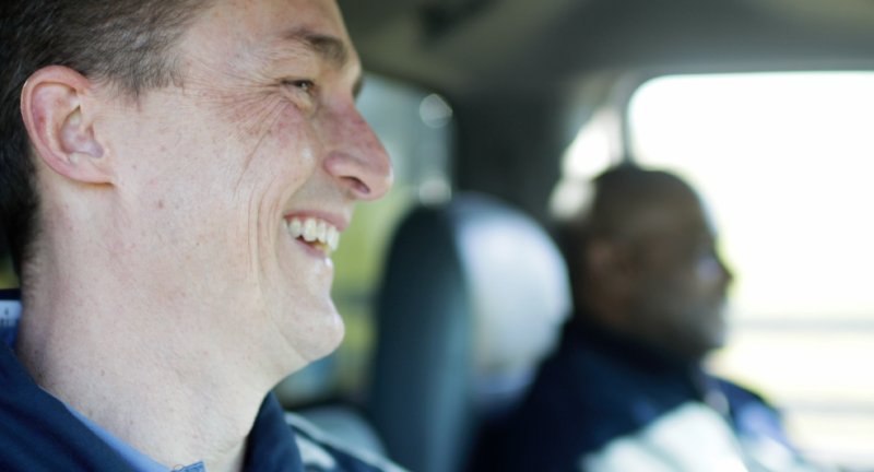 Two Tri-County Pumps technicians in their service truck