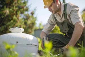 Septic system technician inspecting a tank